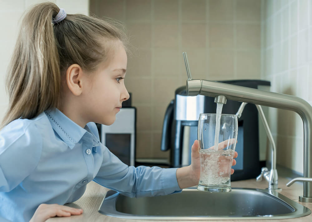 Girl-getting-a-glass-of-clean-drinking-water-in-Gilbert AZ